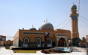 Hannana Mosque is located in the north of Najaf, on the way to Kufa. It is narrated that the site of this mosque lamented for the Ahl al-Bayt (a) two times; when the coffin of Imam 'Ali (a) was being carried and after the event of Karbala, when the holy head of Imam al-Husayn (a) was put on the ground of this mosque. (Featured in November 9, 2015)